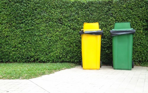 Overview of an organised commercial recycling area showing separated bins and signage